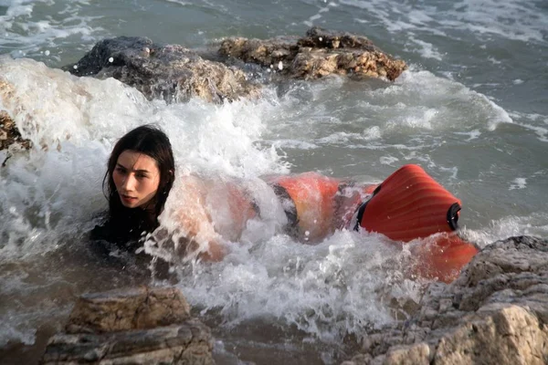 Pretty Asian woman in bikini with Mermaid dresses on fun at a beach.