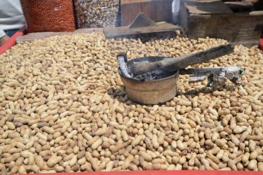 Piyasada bir yığın fıstık var. Sokağın ortasında Sonamarg 'da satılık büyük bir kasede taze pişmiş fıstık yığını. Hindistan.