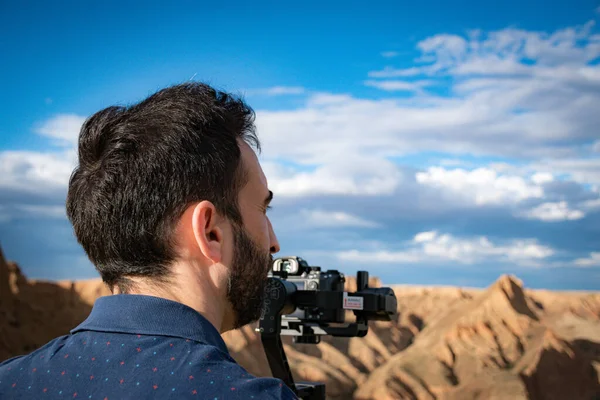 Genç sinemacı, büyük bir nehir ve bataklıklarla kanyondaki doğal manzarayı filme alıyor.