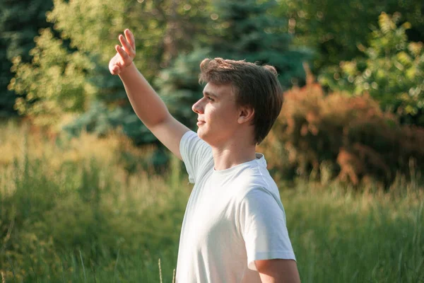 Young Guy Stands Tall Grass Looks Sun — Stock Photo, Image