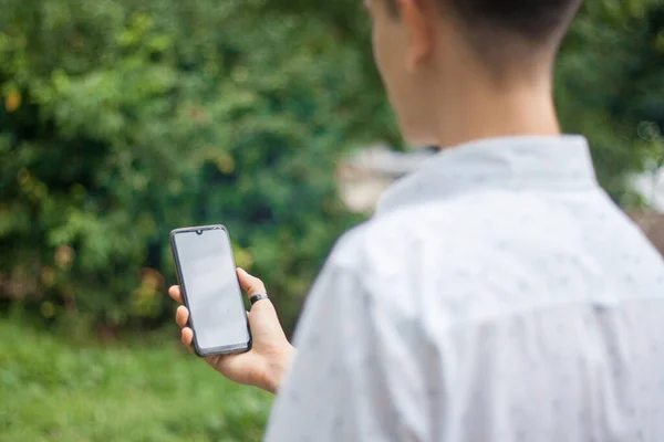 Young man looking at the phone screen