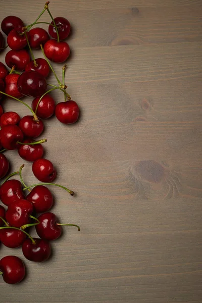 Green spring red cherries on wood background selective focus cherry — Stok Foto