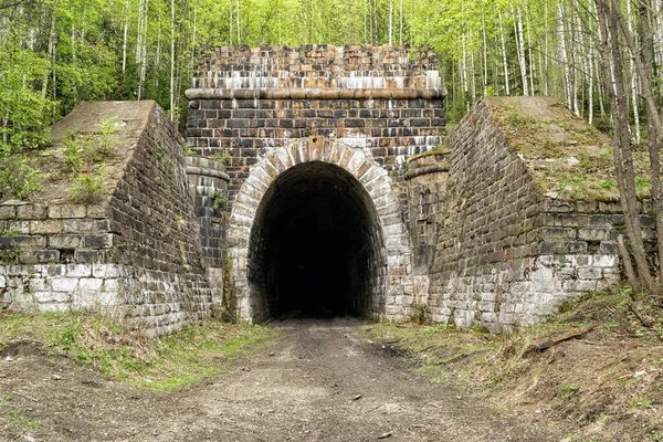 old abandoned railway tunnel, stone-lined tunnel entrance