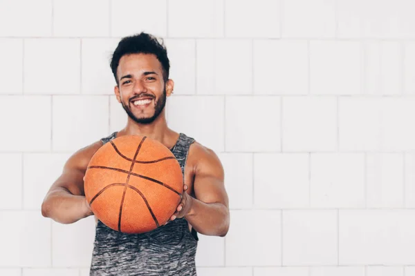 若い男は笑顔でバスケットボールをしながら — ストック写真