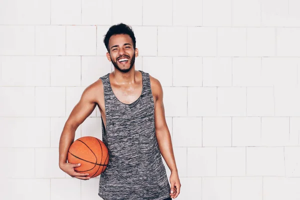 Young Man Holds Basketball While Smiling — Stock Photo, Image