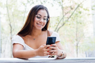 Kadın akıllı telefonuna mesaj yazıyor.