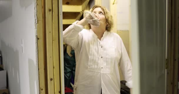 Mature Woman Alcoholic Drinking Hiding Basement Closet Stock