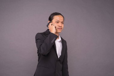 Genç iş adamı akıllı telefonunu kullanıyor..