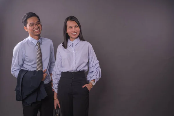 Asian business man and woman.Asian female and male model wearing office attire.Studio shot.