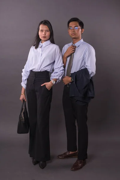 Asian business man and woman.Asian female and male model wearing office attire.Studio shot.