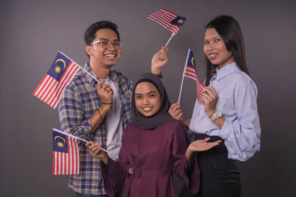 Szczęśliwy Wielorasowy Malezyjczycy Posiadający Flagę Malezji Dzień Niepodległości Patriotyczne Koncept — Zdjęcie stockowe