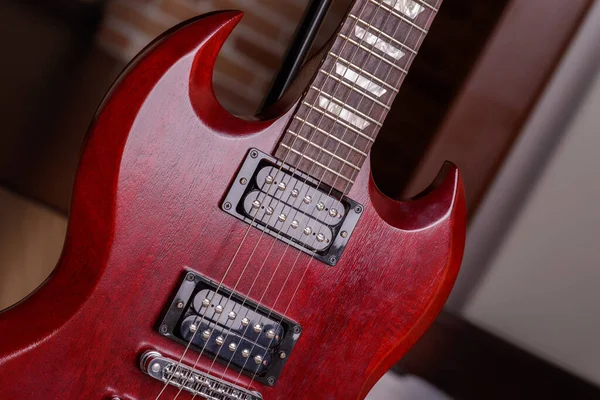 Body red electric guitar close-up