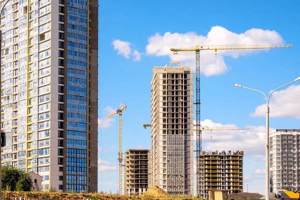 stock image Construction of a modern building. A lot of high-rise cranes. Yellow construction crane on a background of blue sky