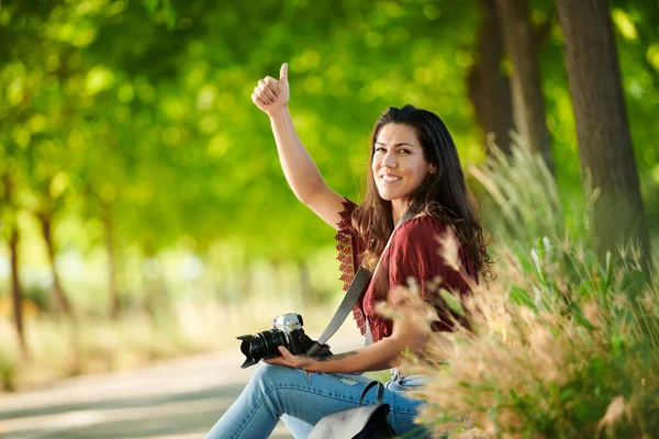 relaxed young girl saying hello to camera