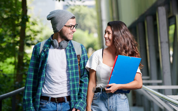 young couple walks very happy through the college