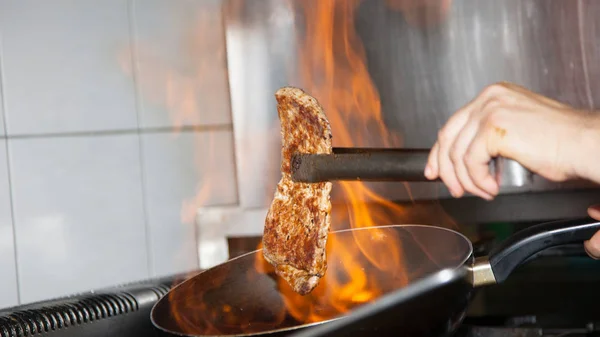 Delicioso Filete Parrilla Con Pinzas Fuego Metal Mano Humana Cerca — Foto de Stock