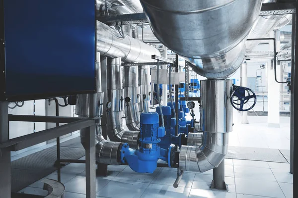 boiler room with pumps and pipe lines supplying steam with pressure gauges installed Blue toning