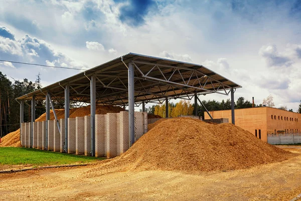 storage for wood chips in the street under a canopy