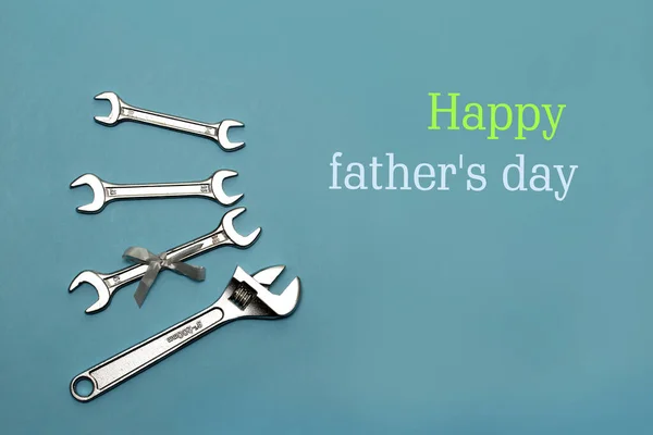 Greeting card for Father\'s Day. Top view of construction tools on a blue background