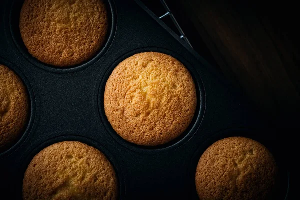 Plain fairy cakes inside a baking tray waiting to be decorated