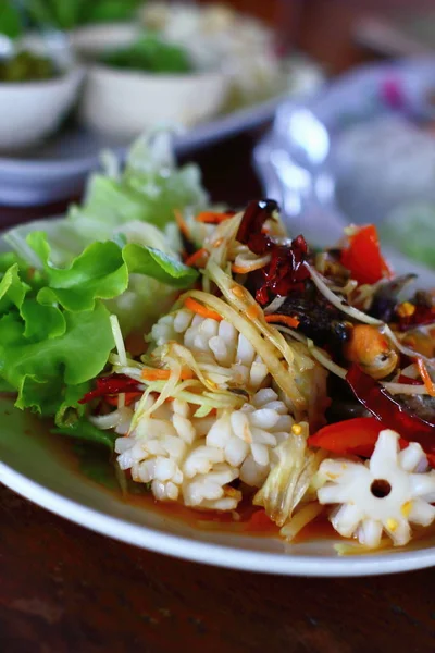 A delicious spicy papaya salad with seafood in thaifood — Stock Photo, Image