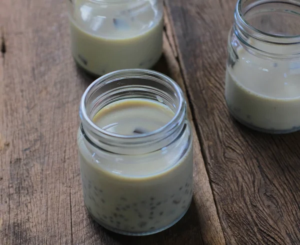 Black sesame soy milk in glass on wood — Stock Photo, Image