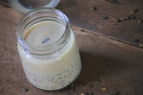 Black sesame soy milk in glass on wood — Stock Photo, Image