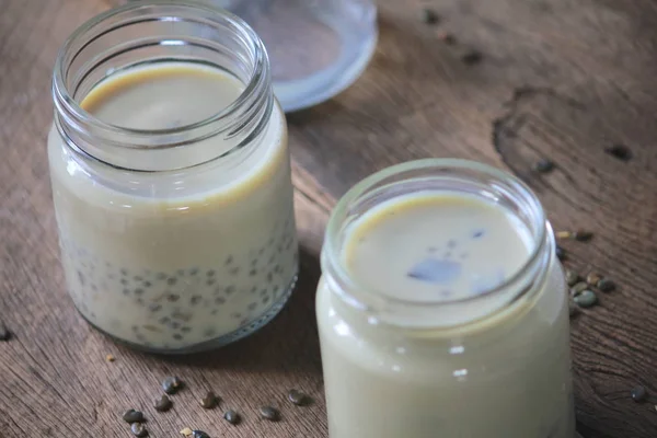 Black sesame soy milk in glass on wood — Stock Photo, Image