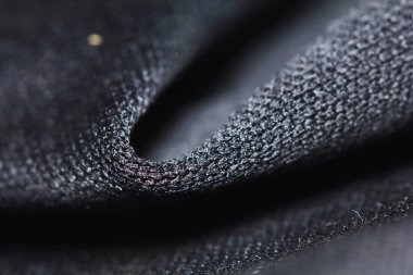 Güzel bir arkaplan için soyut makrodaki kumaşın güzel siyah dokusu