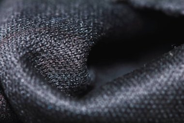 Güzel bir arkaplan için soyut makrodaki kumaşın güzel siyah dokusu