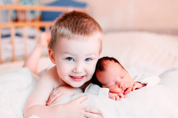 Счастливый Младший Брат Новорожденным Ребенком Лежащим Вместе Постели Целующимся Обнимающимся — стоковое фото