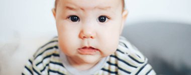 siyah gözleri ve siyah saç ağlamak ile mutsuz ciddi bebek kız portresi. Kazak kız