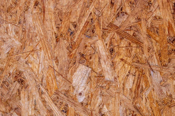 OSB 보 드는 갈색 나무칩을 나무 배경에 깔아서 만든다. OSB 목조 베니어 배경, 단단하고 매끈 한 표면의 맨 위 사진 — 스톡 사진