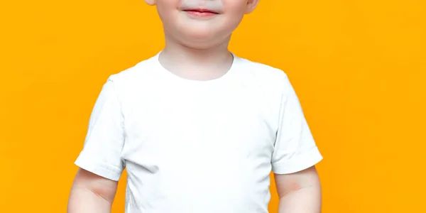 Portrait of smiling happy child 3 years old mixed race half Asian half Caucasian on yellow background with blonde hair and green eyes — Stock Photo, Image