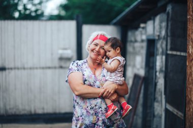 Güneşli yaz gününde doğada Büyükanne sarılma torunu