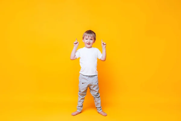 Cute Boy Yellow Background Points His Hand Side Photo Advertising — Stock Photo, Image