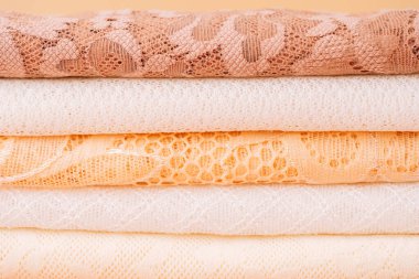 Stack of pastel lace fabrics, closeup layers. High quality photo