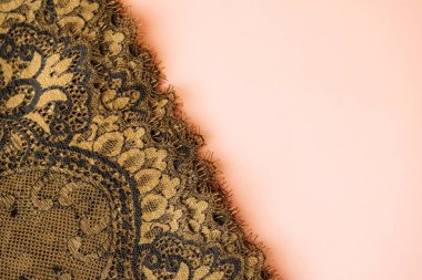 Gold lace edge on peach background, detail. High quality photo