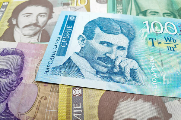 Stack of Serbian dinar banknotes as background.