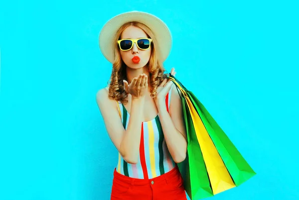 Portrait young woman blowing red lips sends air kiss with shoppi — Stock Photo, Image