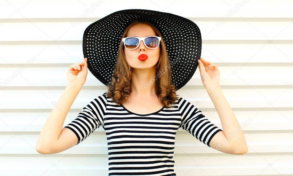 Portrait young woman blowing red lips sending sweet air kiss in 