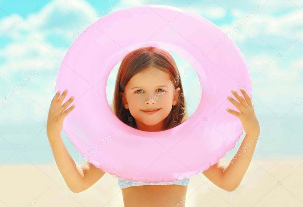 Summer portrait close-up little girl child with inflatable circl