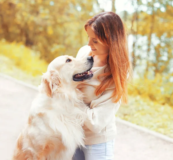 Portret fericit zâmbind femeie cu Golden Retriever câine uitându-se unul la altul în parc — Fotografie, imagine de stoc