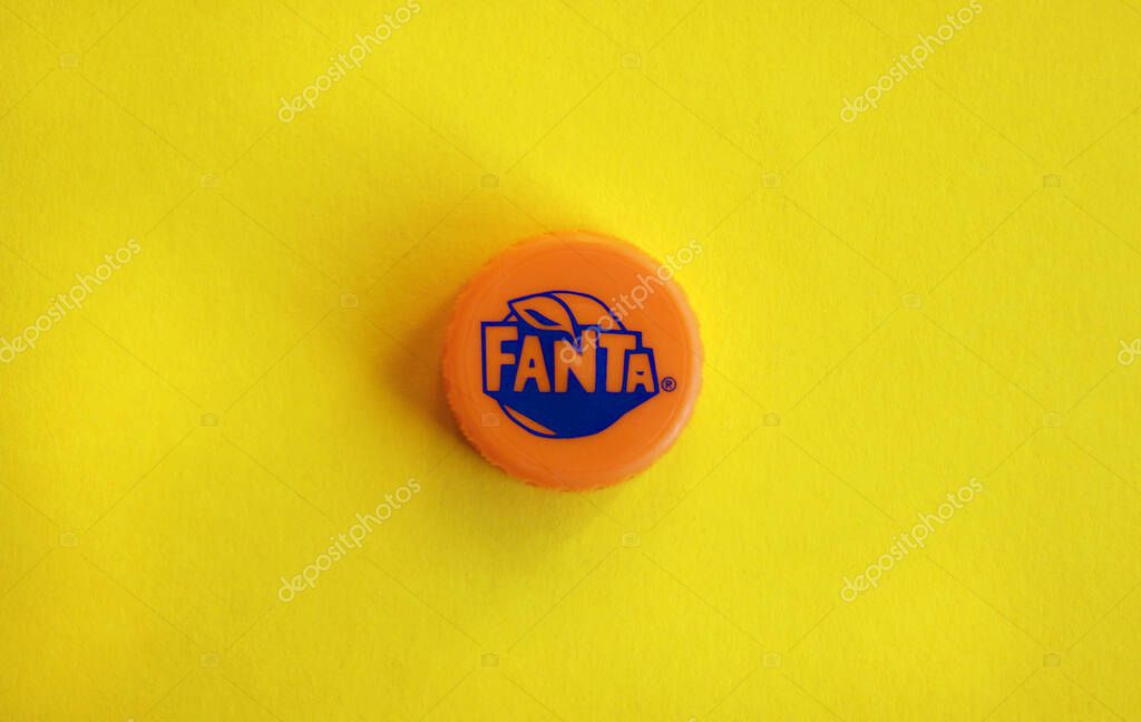 KHARKOV, UKRAINE - NOVEMBER 24, 2019: orange cap with fanta logo on yellow background