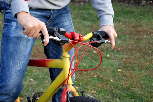 Young Guy Cycling Park Hands Steering Wheel Bright Yellow Red — Stock Photo, Image