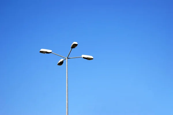 Street lamps with economical lamps with on a background of cloudless sky.