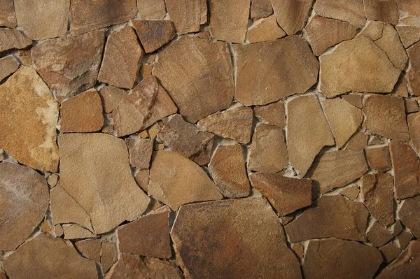 Light brown stone texture. Stone wall grunge background. Modern architecture, granite structure. Cement construction material