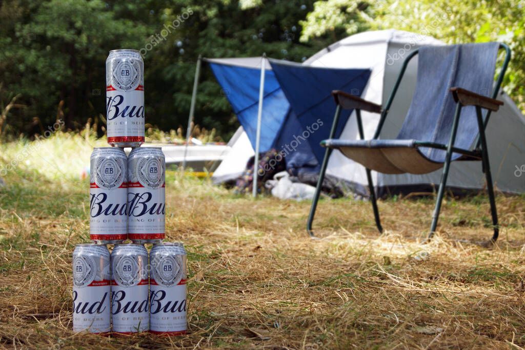 KHARKOV, UKRAINE - AUGUST 23, 2020 : Several metal cans of Budweiser Bud beer outdoors. Budweiser is one of the most popular beer brands in the United States.