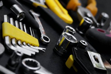 Many different tools for repair work on a black background. Repair and construction concept.