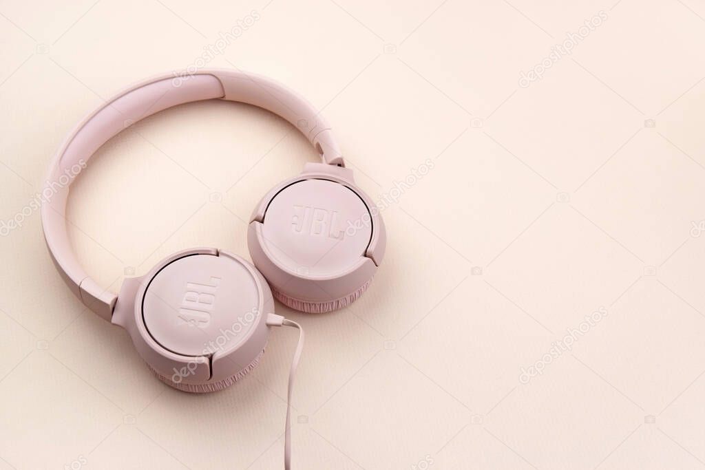 Kharkiv, Ukraine, July 06, 2023: JBL T500 Pink wired headphones with deep bass.
